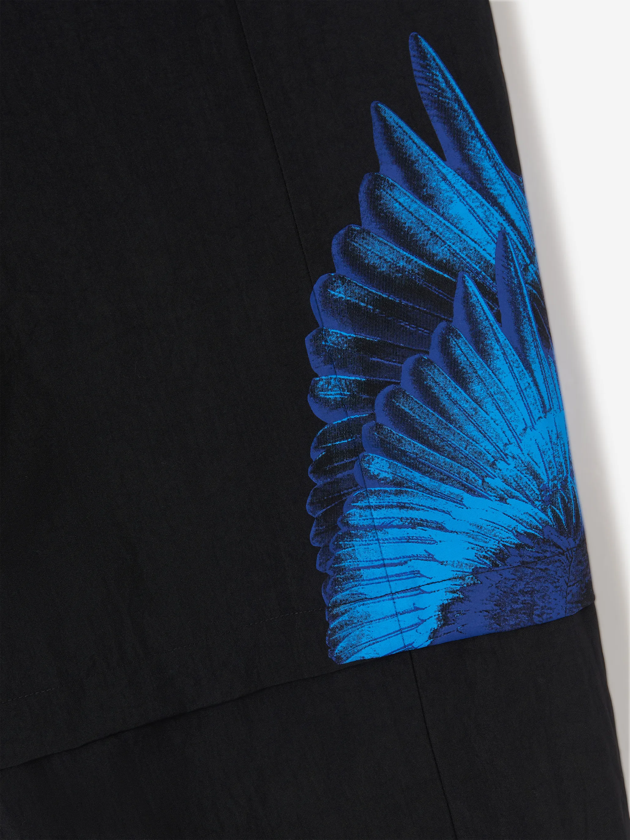 Black/blue x FILA feather print trousers from Marcelo Burlon County of Milan featuring feather print, logo patch to the side, slip pockets to the sides, elasticated waistband, front button and zip fastening and elasticated ankles.