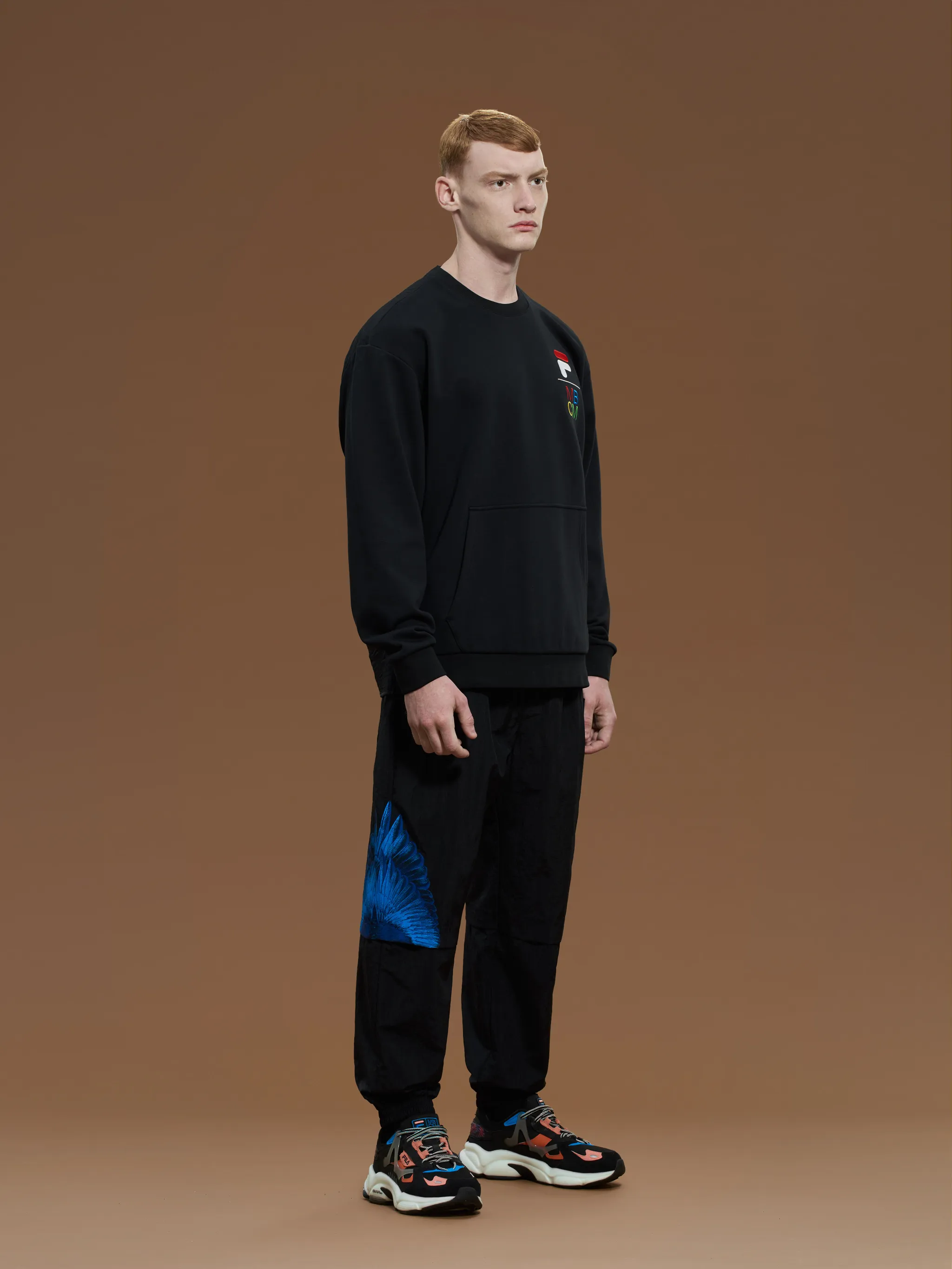 Black cotton-blend x FILA embroidered bomber jacket from Marcelo Burlon County of Milan featuring logo patch to the front, baseball collar, front zip fastening, front zip fastening pockets, long sleeves, straight hem and embroidered design.