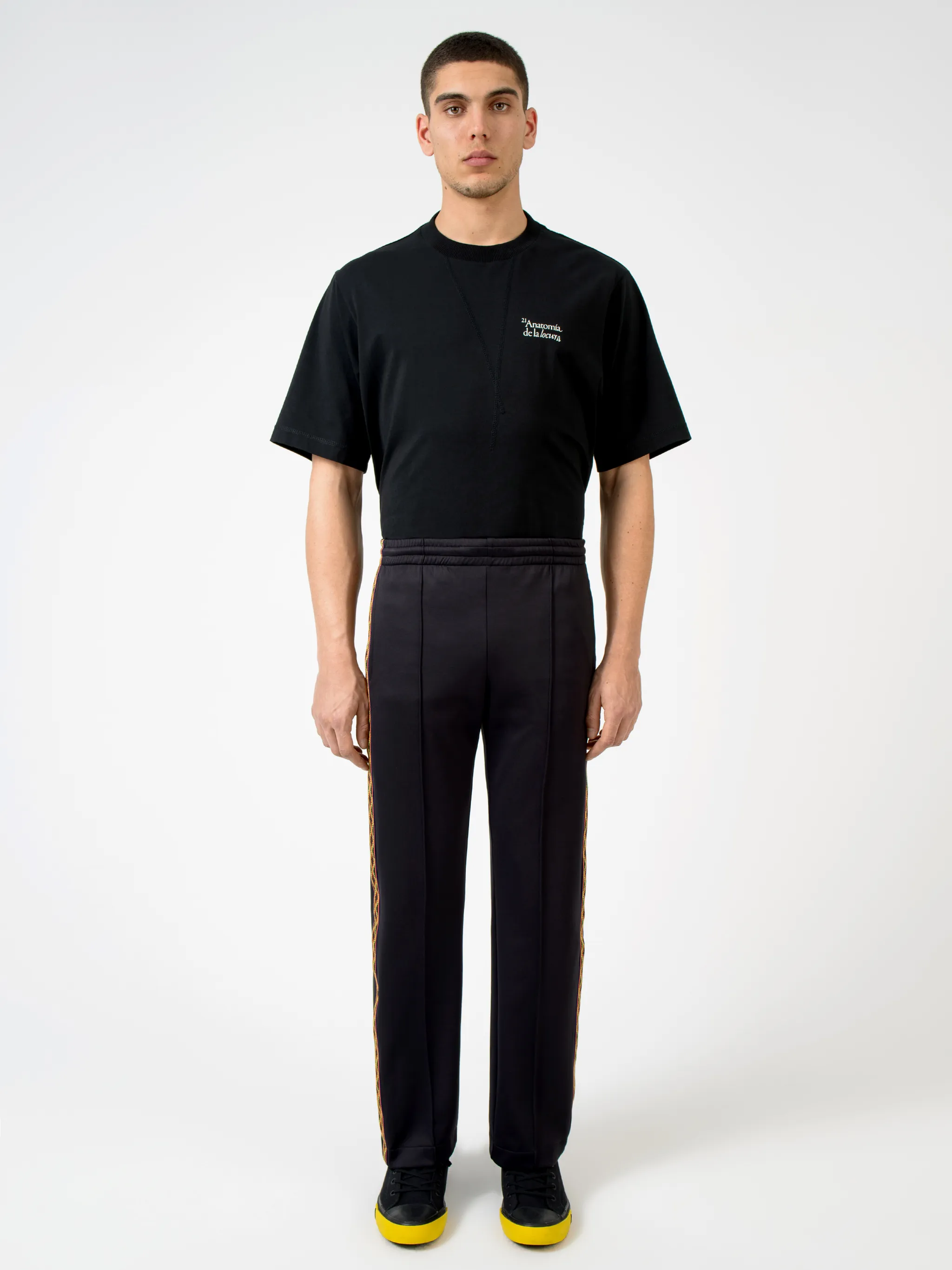 Black/orange/beige cotton-blend Folk tape panel track pants from Marcelo Burlon County of Milan featuring logo-tape detailing, elasticated waistband, two side patch pockets, rear patch pocket, embroidered logo to the rear and straight leg.