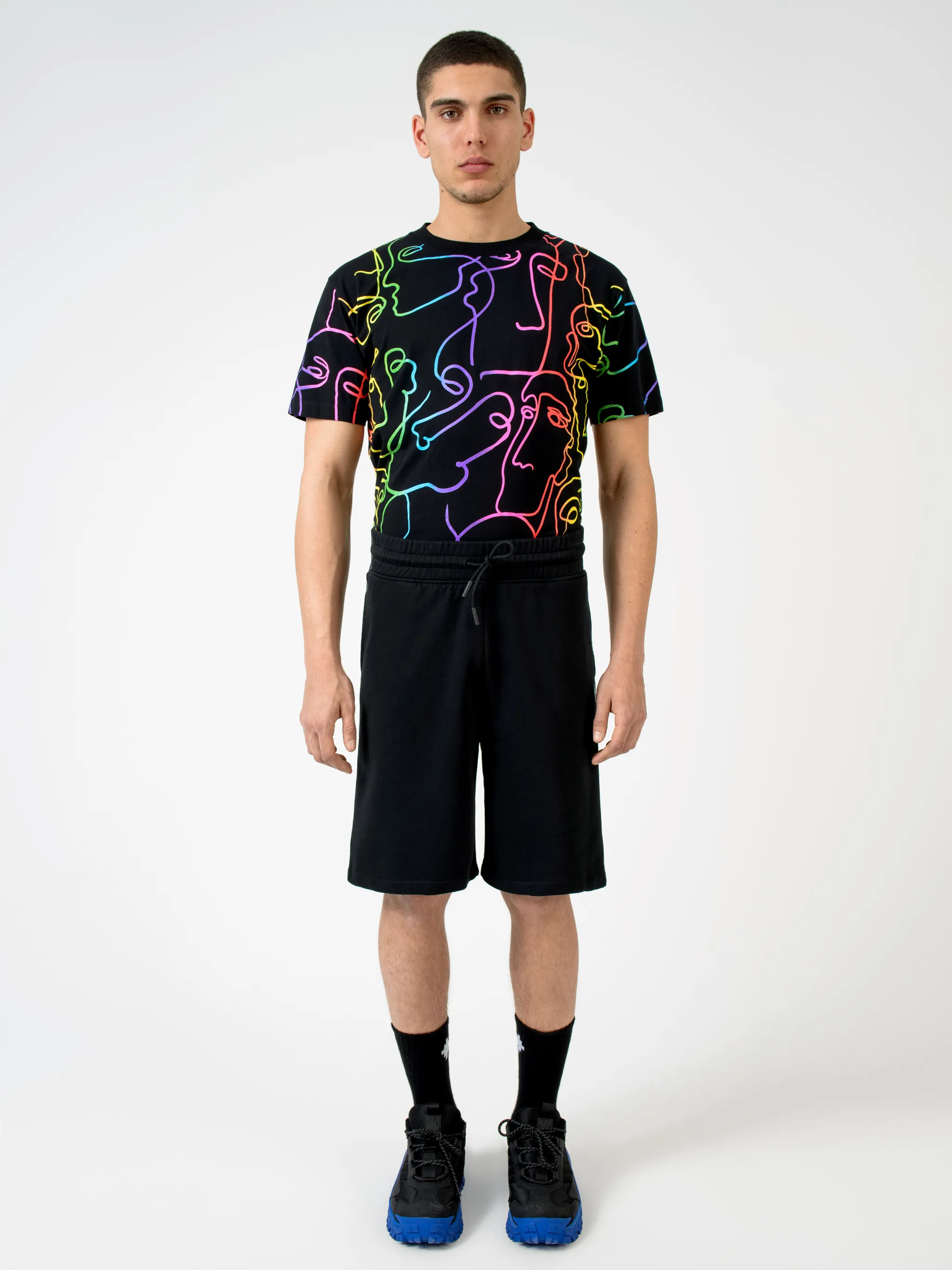 Black cotton printed Illustrated track shorts from Marcelo Burlon County of Milan featuring logo print to the rear, elasticated waistband, drawstring fastening, two side patch pockets, embroidered logo, rear pouch pocket and tonal stitching.