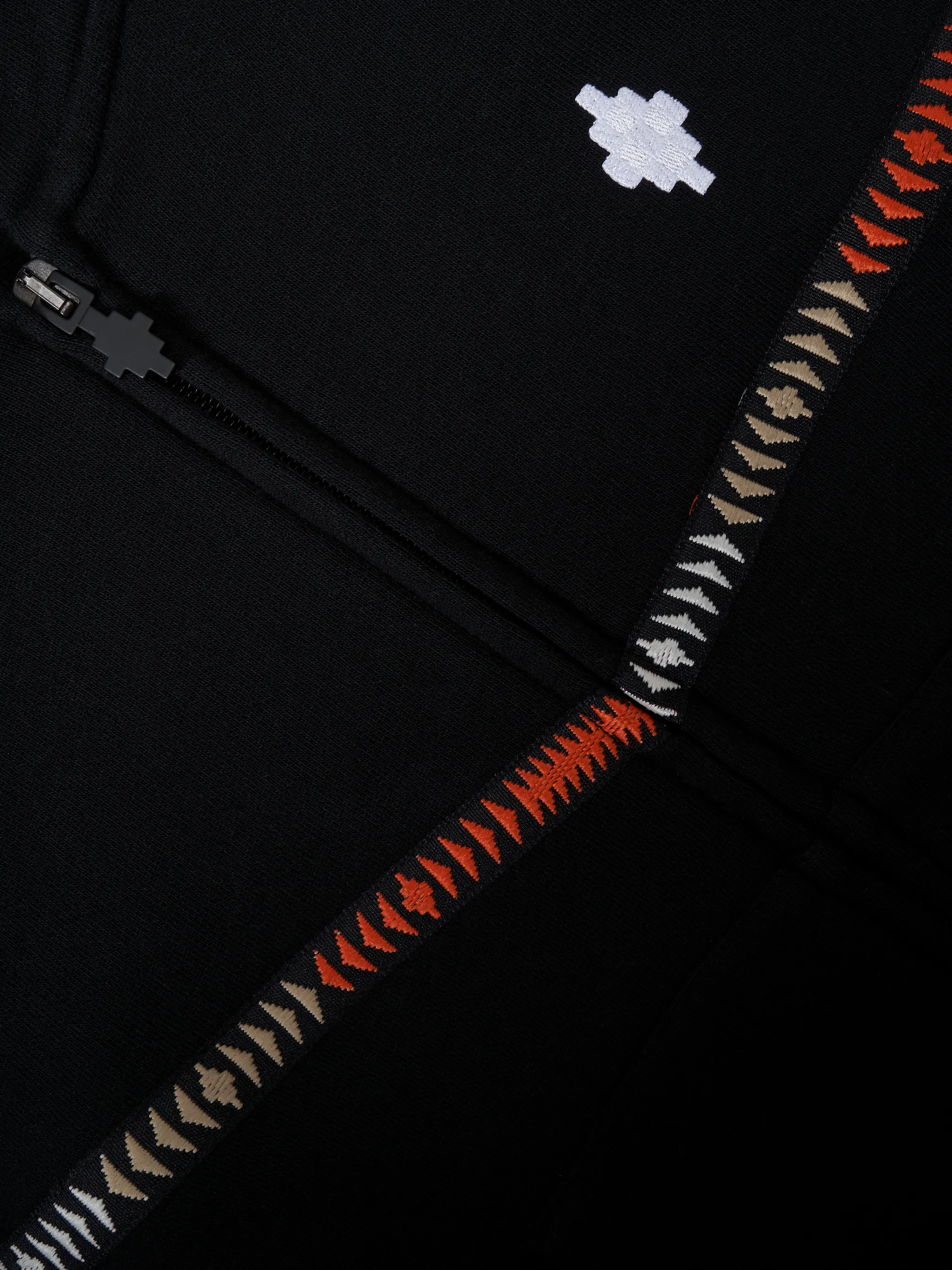 Black tape detail logo hoodie from Marcelo Burlon Kids featuring tape detailing, embroidered logo at the chest, classic hood, long sleeves, front zip fastening and two front patch pockets.