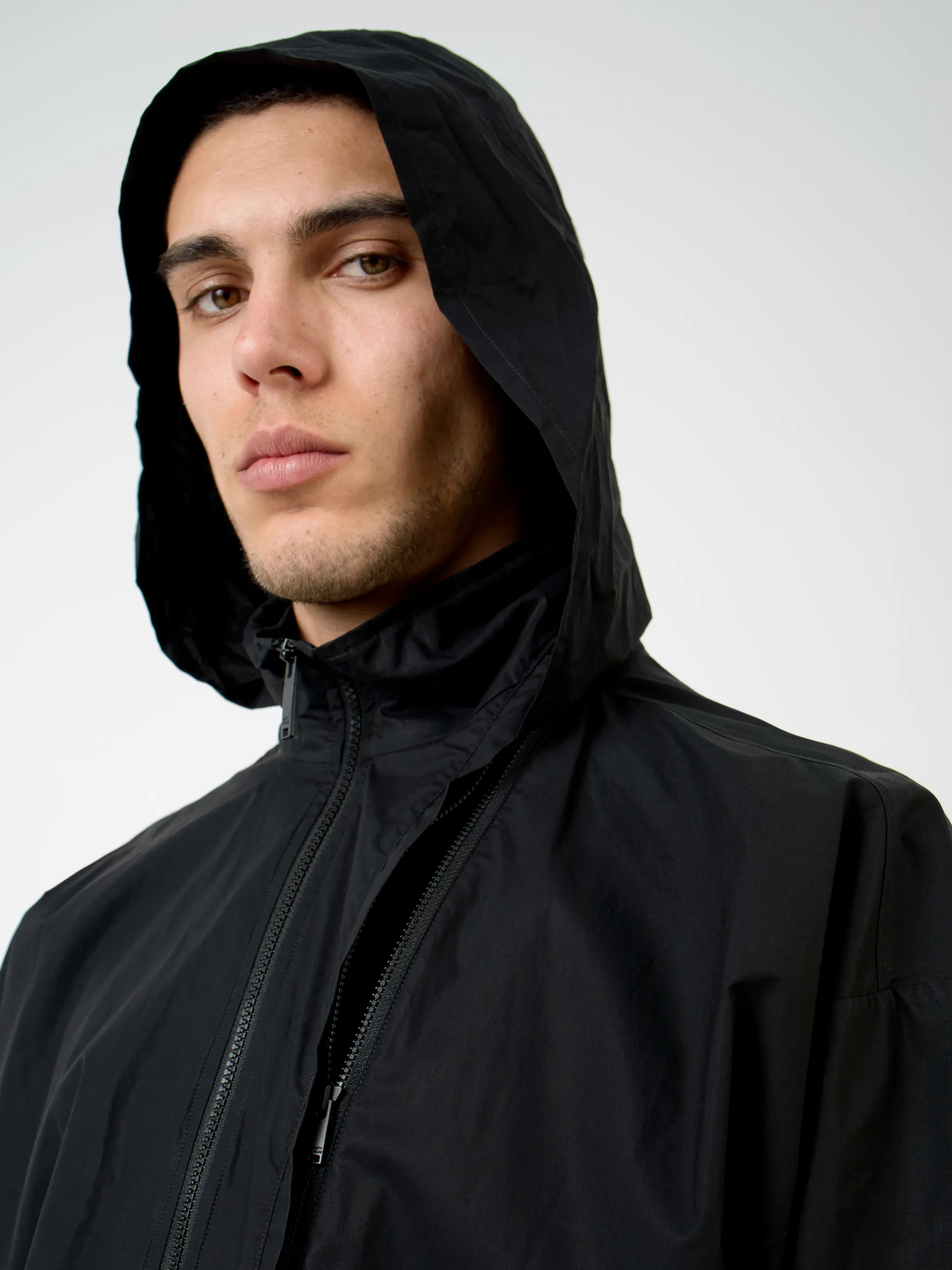 Black cotton-blend logo-print zip-up track jacket from Marcelo Burlon County of Milan featuring logo print to the rear, concealed hood, high neck, front zip fastening, long sleeves, elasticated cuffs and elasticated hem.