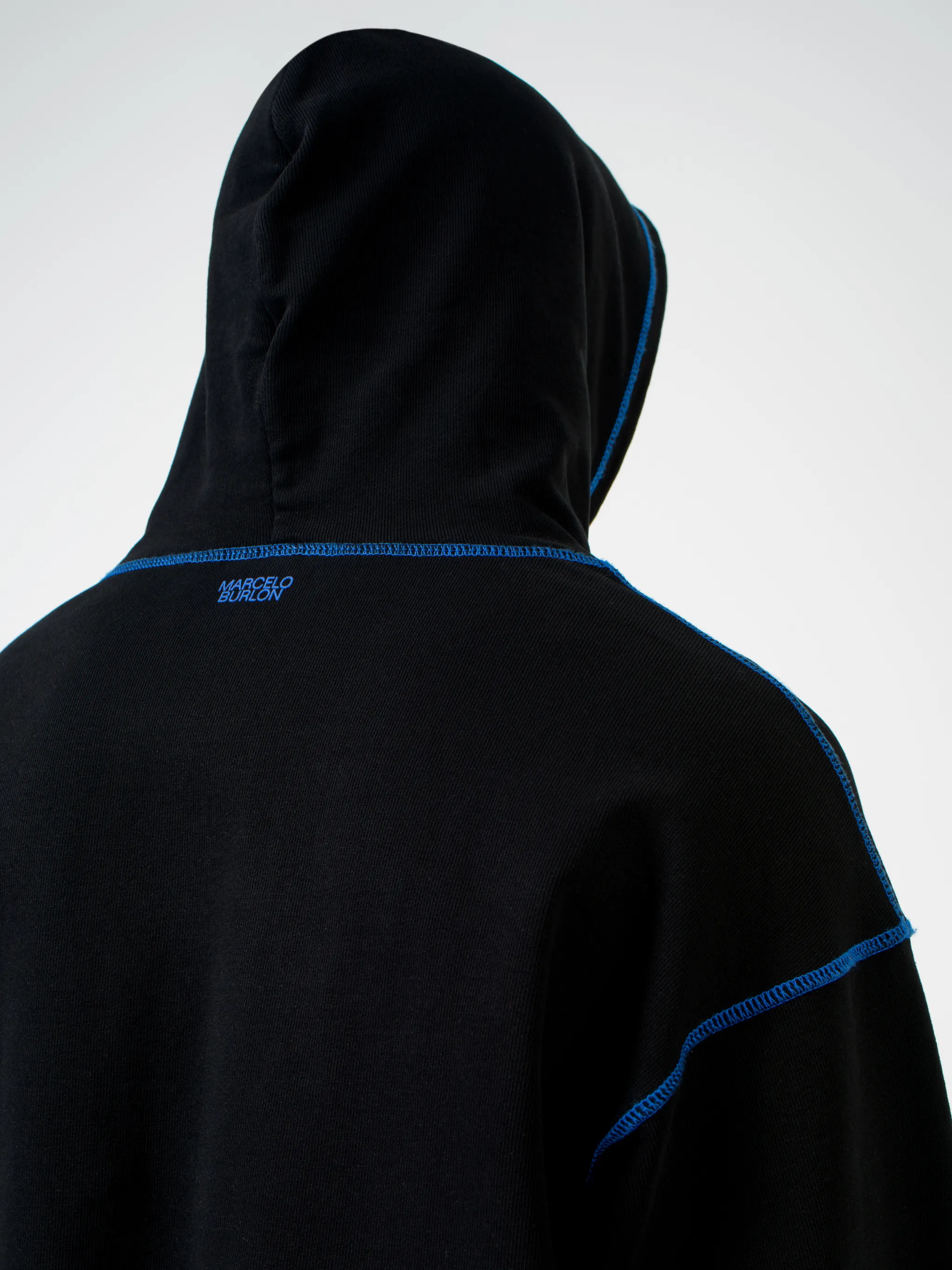 Black Mad Face cotton hoodie from Marcelo Burlon County of Milan featuring graphic print, logo print to the rear, contrasting trim, drawstring hood, long sleeves and straight hem.
