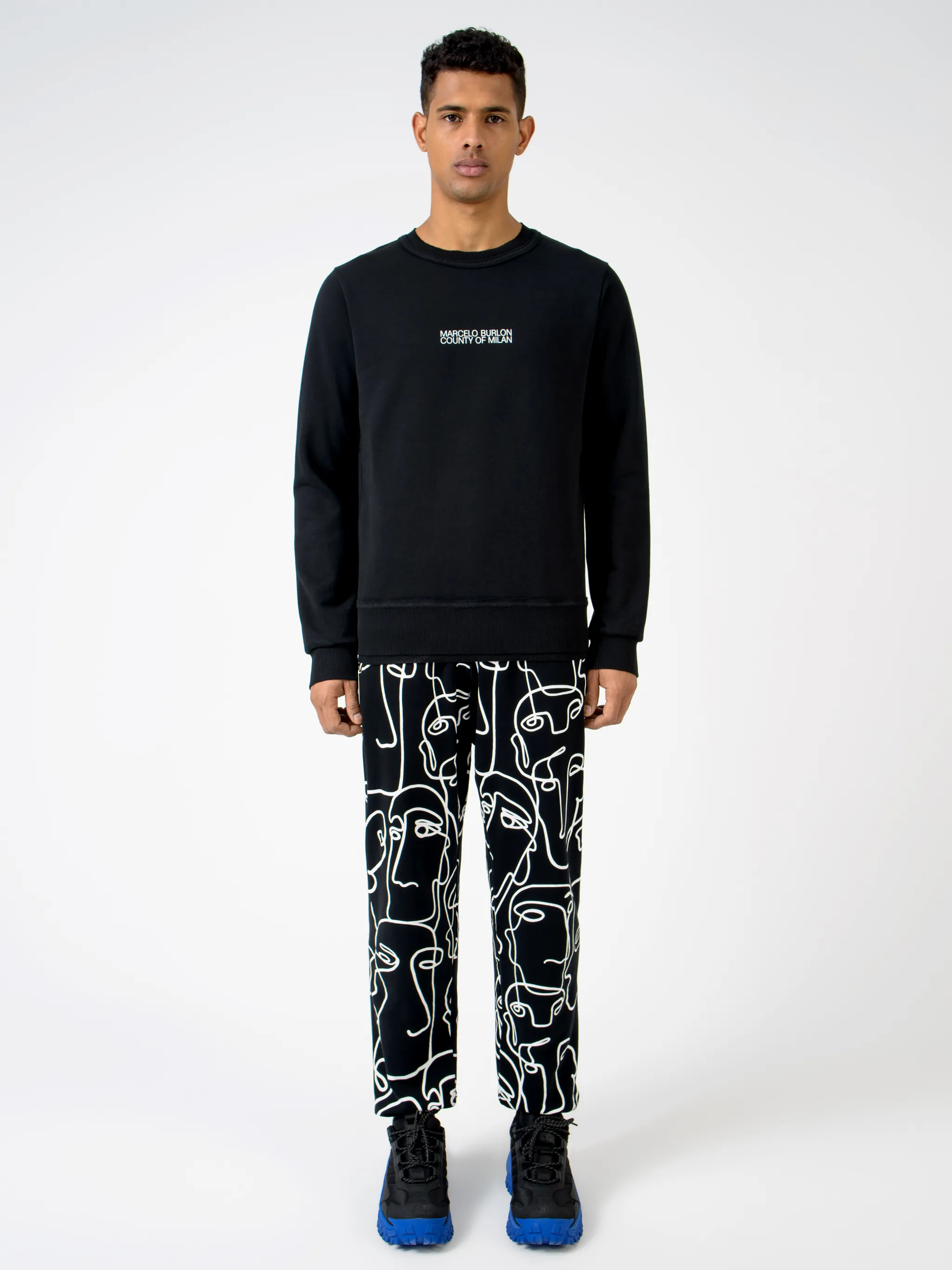 Black cotton Multi Faces crew-neck sweatshirt from Marcelo Burlon County of Milan featuring logo print at the chest, graphic print to the rear, crew neck, long raglan sleeves and straight hem.