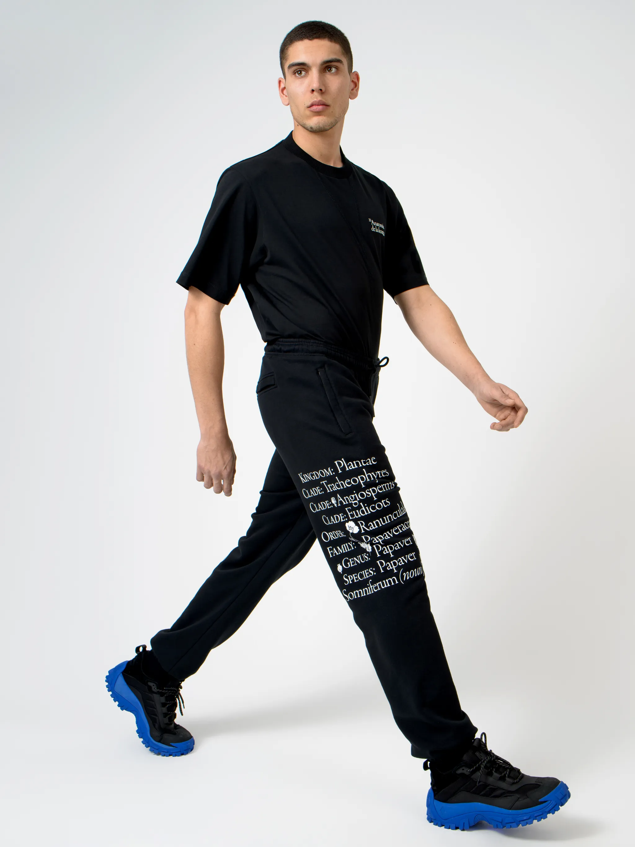 Black cotton Papaver tapered track pants from Marcelo Burlon County of Milan featuring embroidered logo to the front, slogan print, elasticated ankles, elasticated waistband, drawstring fastening, tapered design, two side slit pockets and rear welt pocket.
