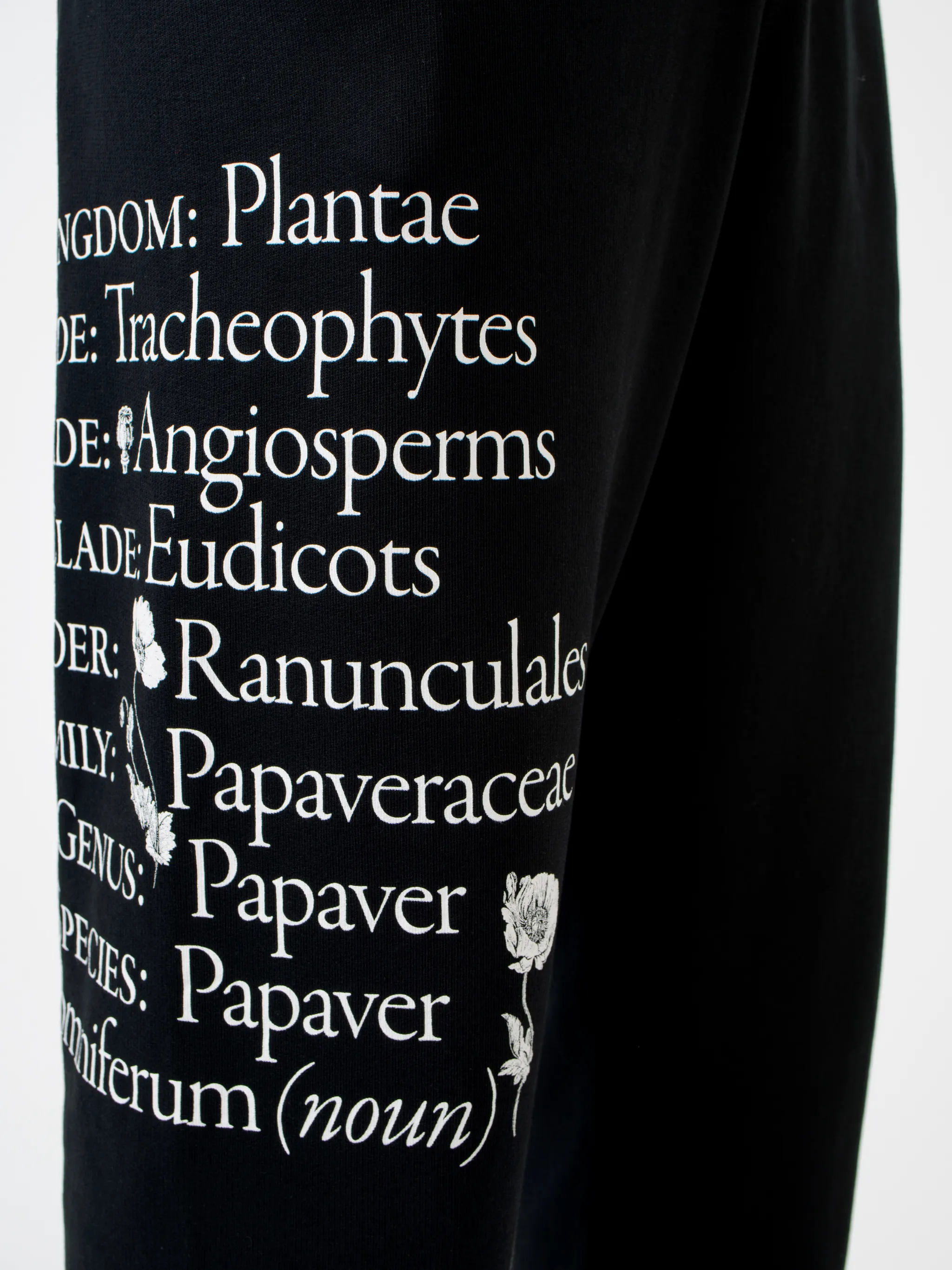 Black cotton Papaver tapered track pants from Marcelo Burlon County of Milan featuring embroidered logo to the front, slogan print, elasticated ankles, elasticated waistband, drawstring fastening, tapered design, two side slit pockets and rear welt pocket.