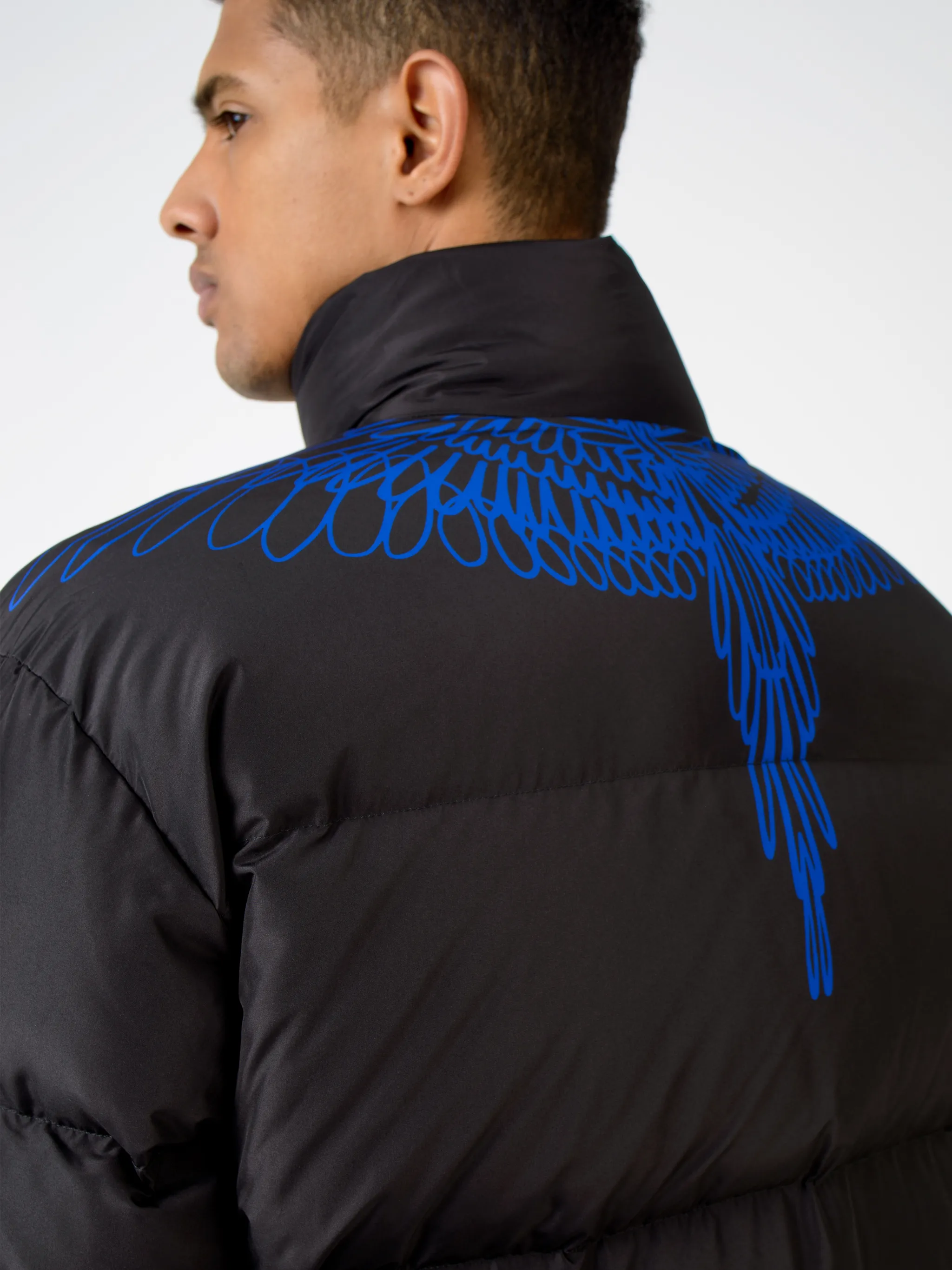 Black/blue wings-detail padded coat from MARCELO BURLON COUNTY OF MILAN featuring stand-up collar, long sleeves, front zip fastening, Wings print and padded.