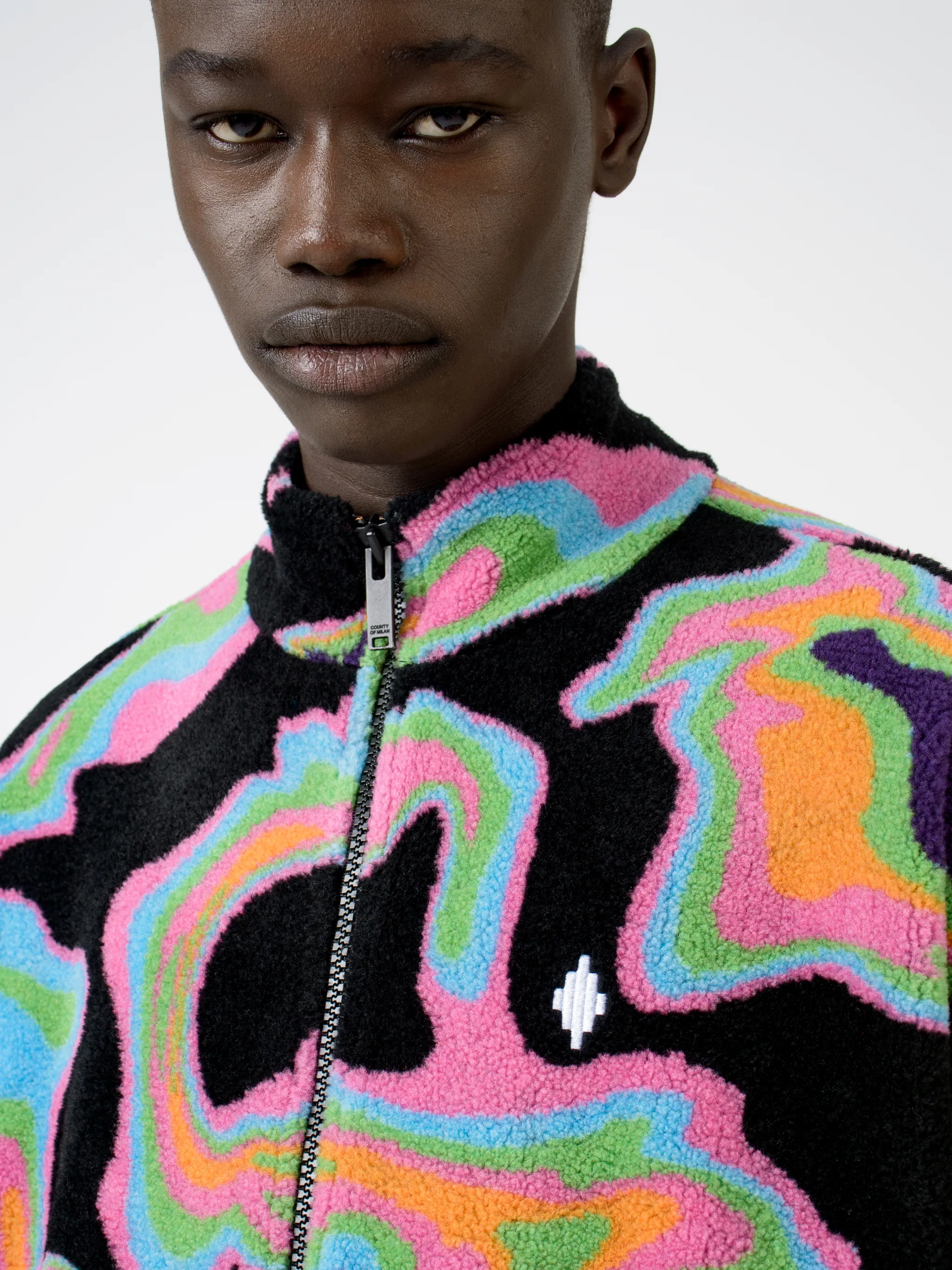 Black/multicolour intarsia Psych pattern track jacket from Marcelo Burlon County of Milan featuring patterned intarsia knit, stand-up collar, front zip fastening, long sleeves, elasticated cuffs and elasticated hem.