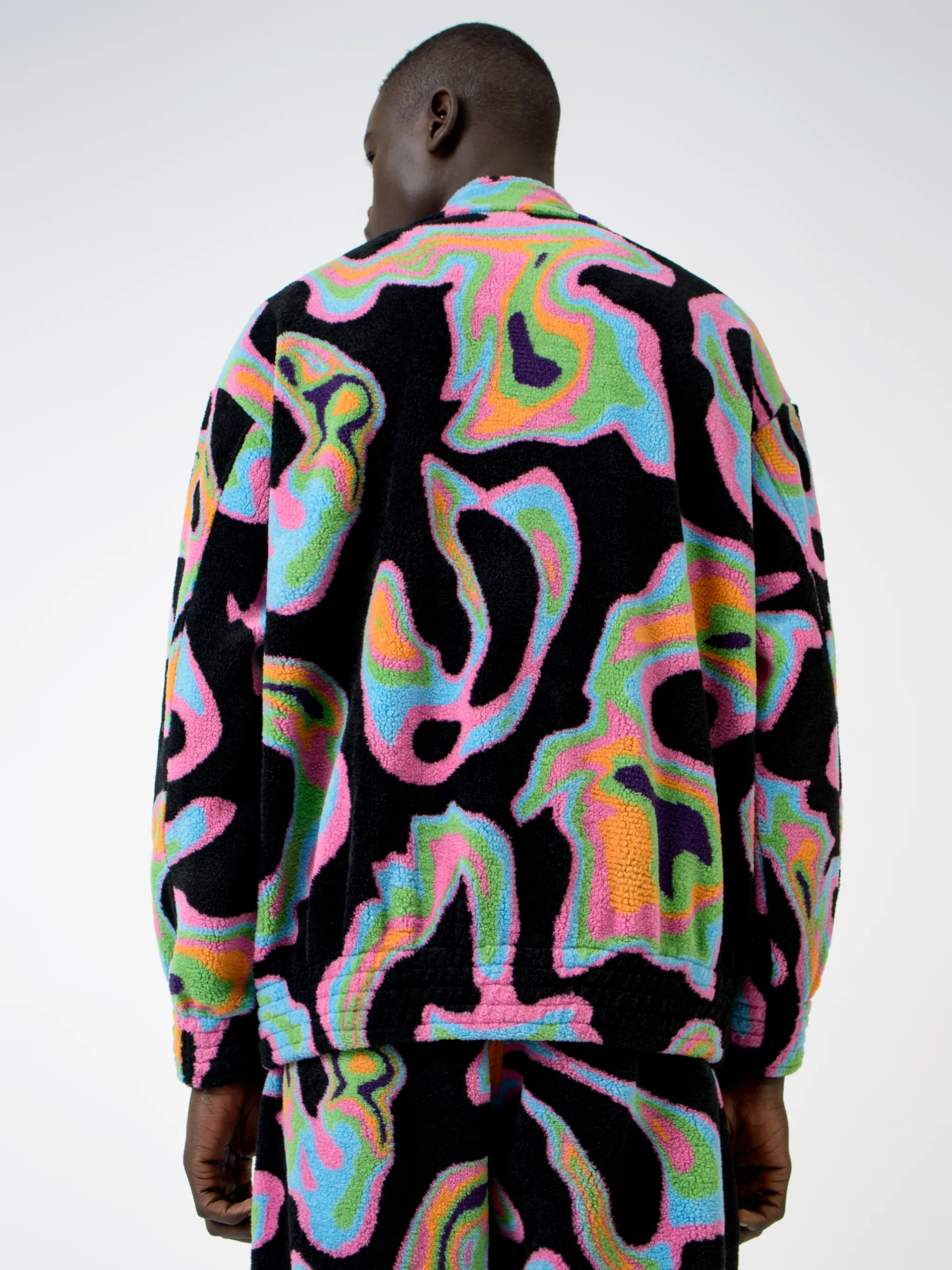 Black/multicolour intarsia Psych pattern track jacket from Marcelo Burlon County of Milan featuring patterned intarsia knit, stand-up collar, front zip fastening, long sleeves, elasticated cuffs and elasticated hem.