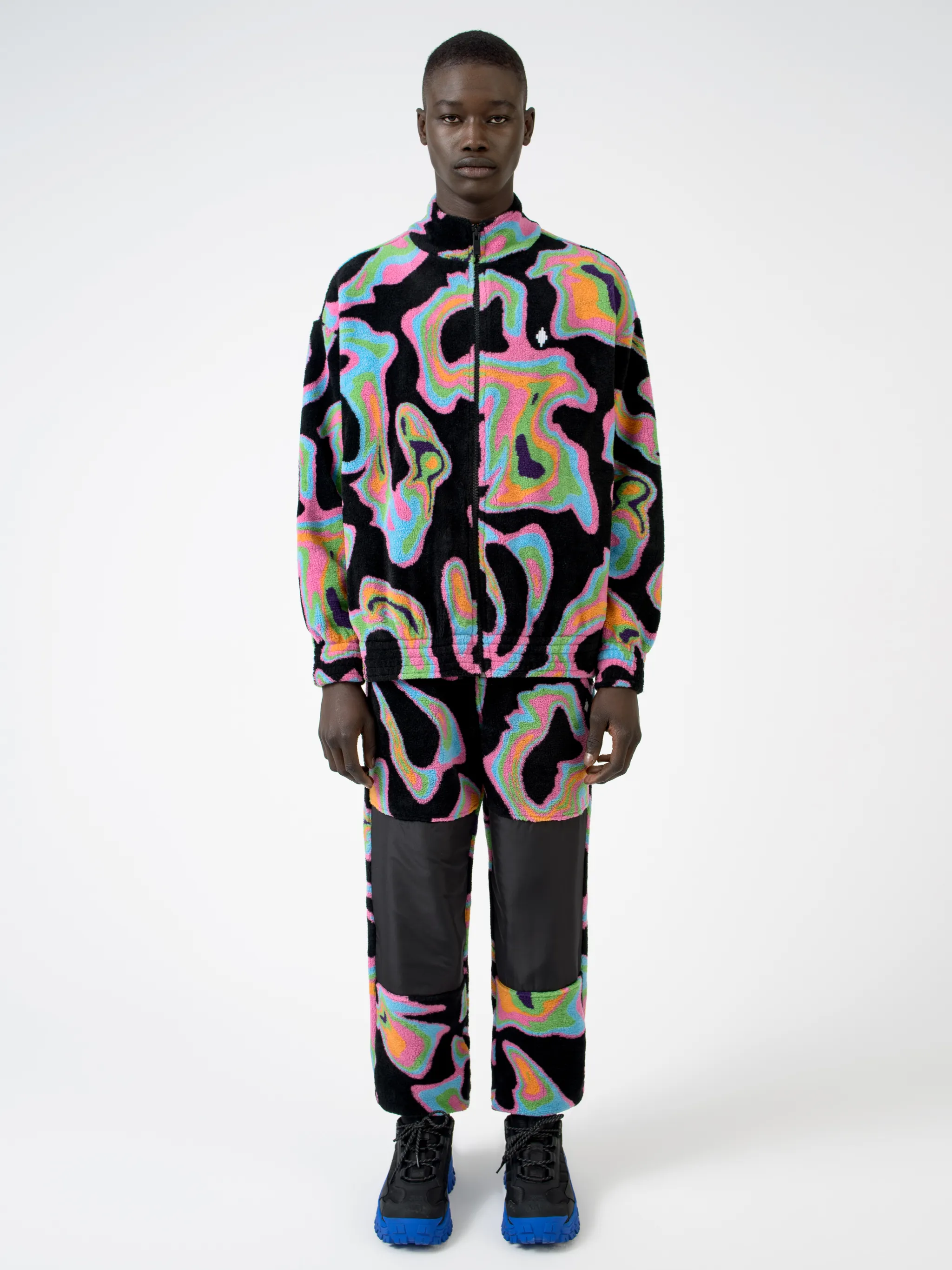 Black/multicolour intarsia Psych pattern track jacket from Marcelo Burlon County of Milan featuring patterned intarsia knit, stand-up collar, front zip fastening, long sleeves, elasticated cuffs and elasticated hem.