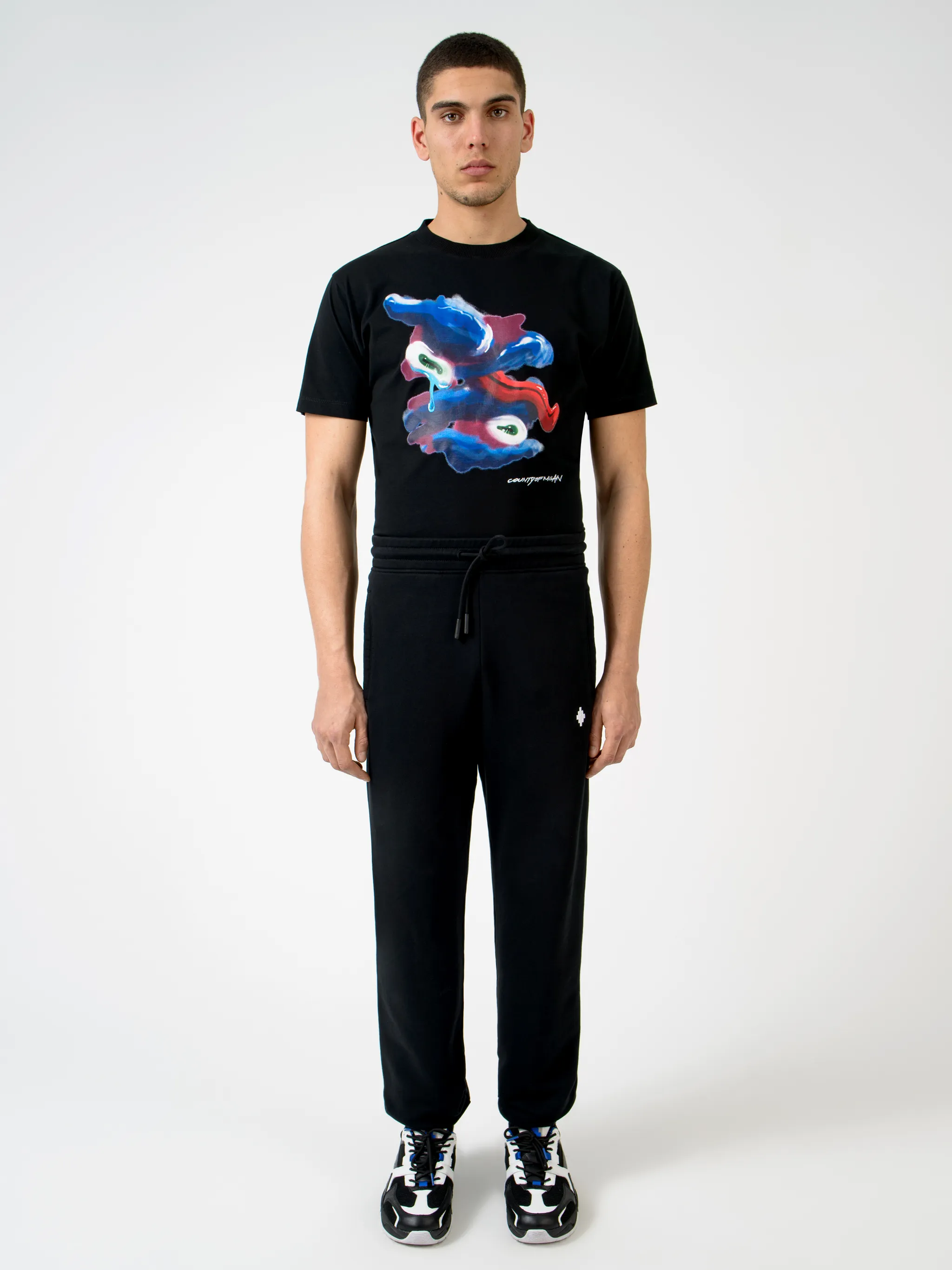 Black cotton rear Psychedelic Wings track pants from Marcelo Burlon County of Milan featuring wings print, elasticated waistband, drawstring fastening, embroidered logo, two side patch pockets, rear patch pocket and elasticated ankles.