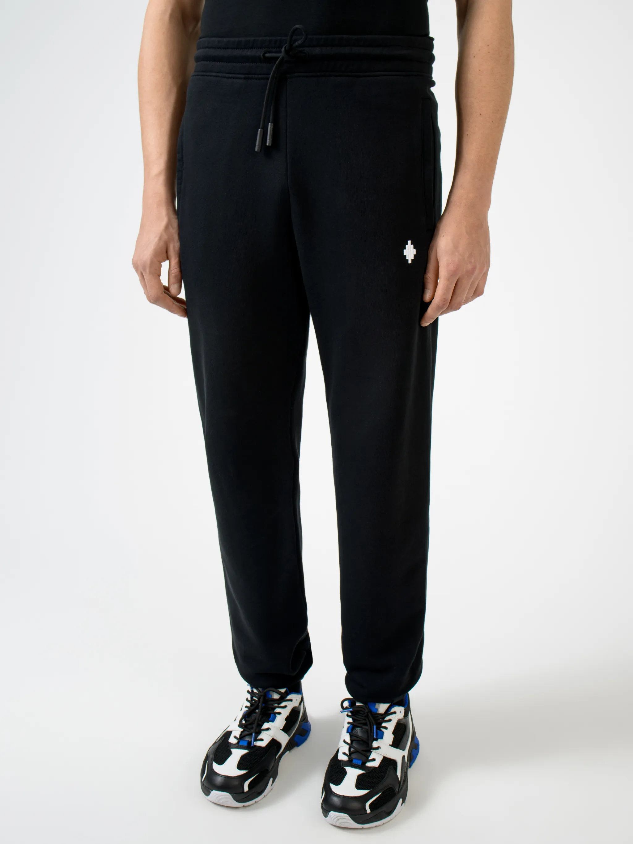 Black cotton rear Psychedelic Wings track pants from Marcelo Burlon County of Milan featuring wings print, elasticated waistband, drawstring fastening, embroidered logo, two side patch pockets, rear patch pocket and elasticated ankles.