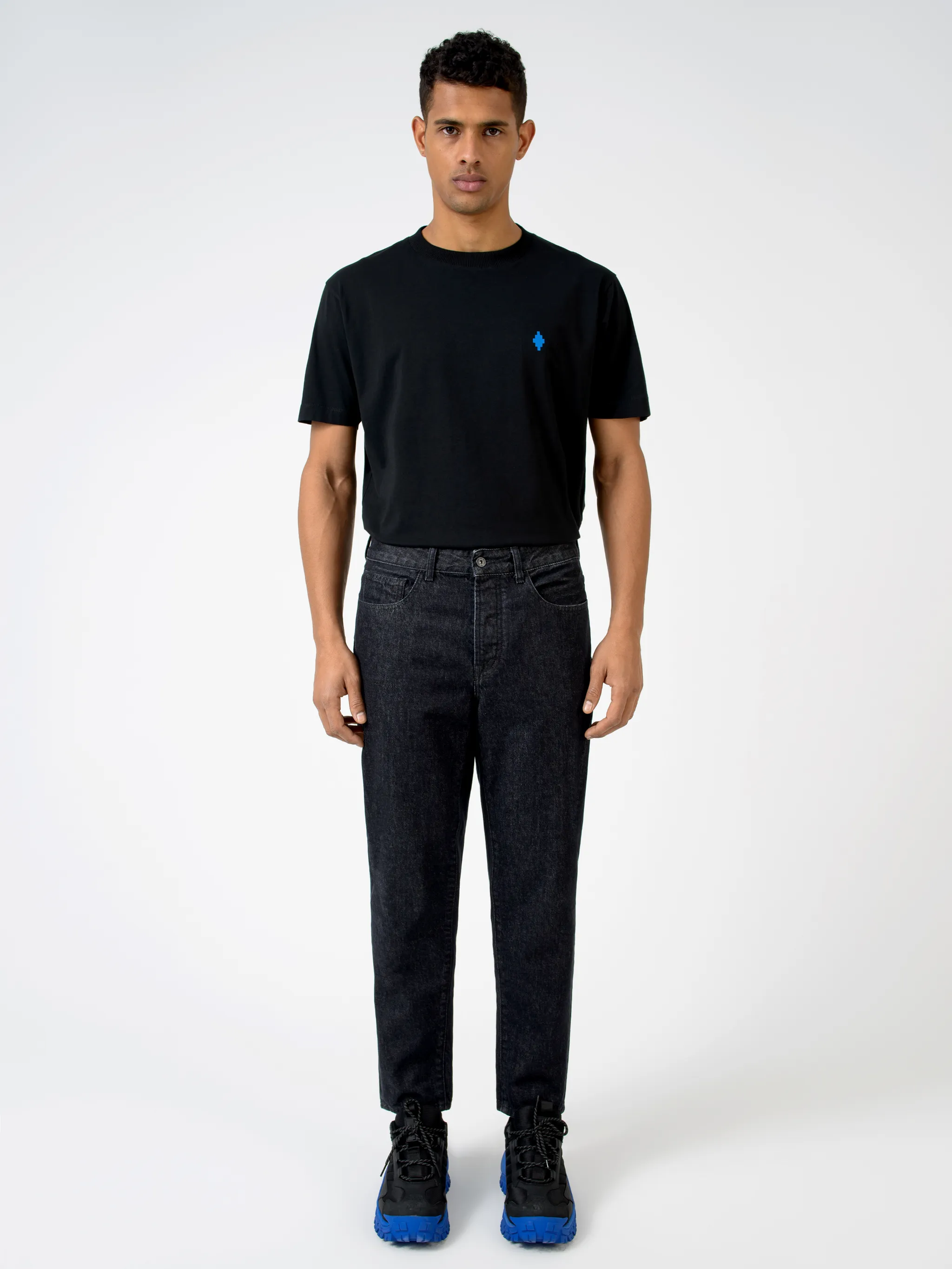 Black cotton Rural Cross slim-fit jeans from Marcelo Burlon County of Milan featuring logo patch to the rear, belt loops, mid-rise, front button and zip fastening, slim cut, classic five pockets and cross print.