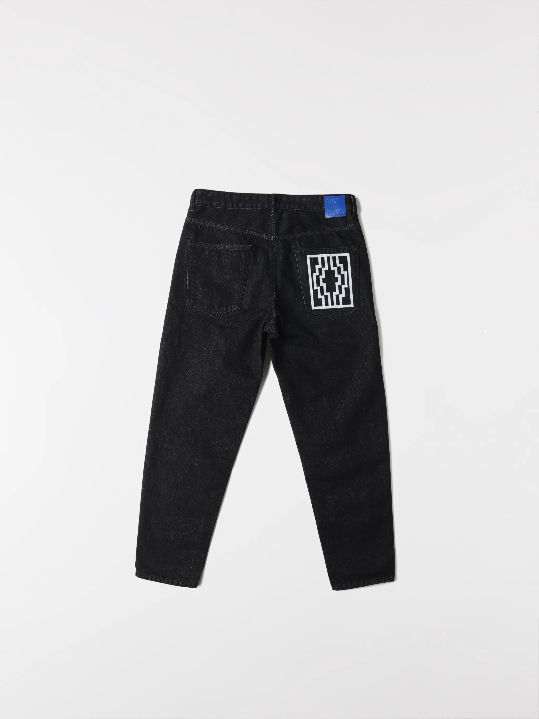 Black cotton Rural Cross slim-fit jeans from Marcelo Burlon County of Milan featuring logo patch to the rear, belt loops, mid-rise, front button and zip fastening, slim cut, classic five pockets and cross print.