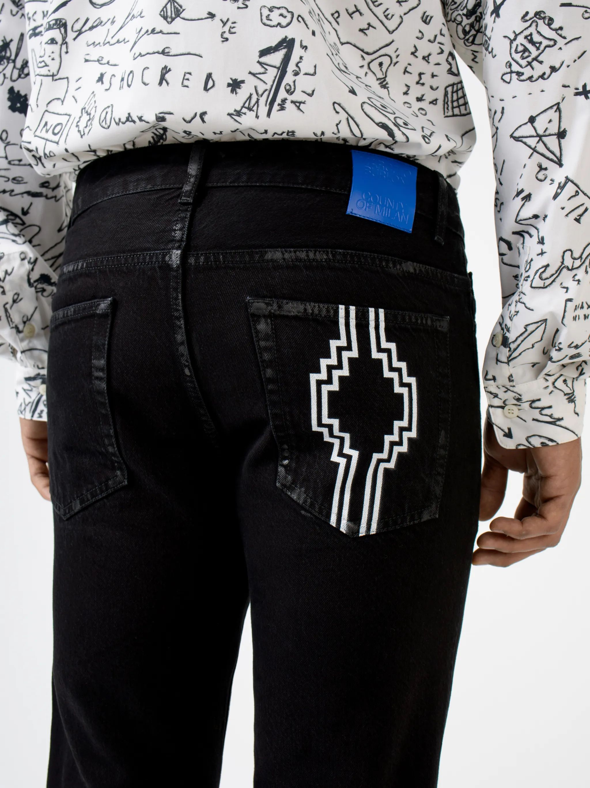 Black cotton-blend Rural Cross slim-fit jeans from Marcelo Burlon County of Milan featuring logo print embellishment, slim cut, belt loops, front button fastening and classic five pockets.