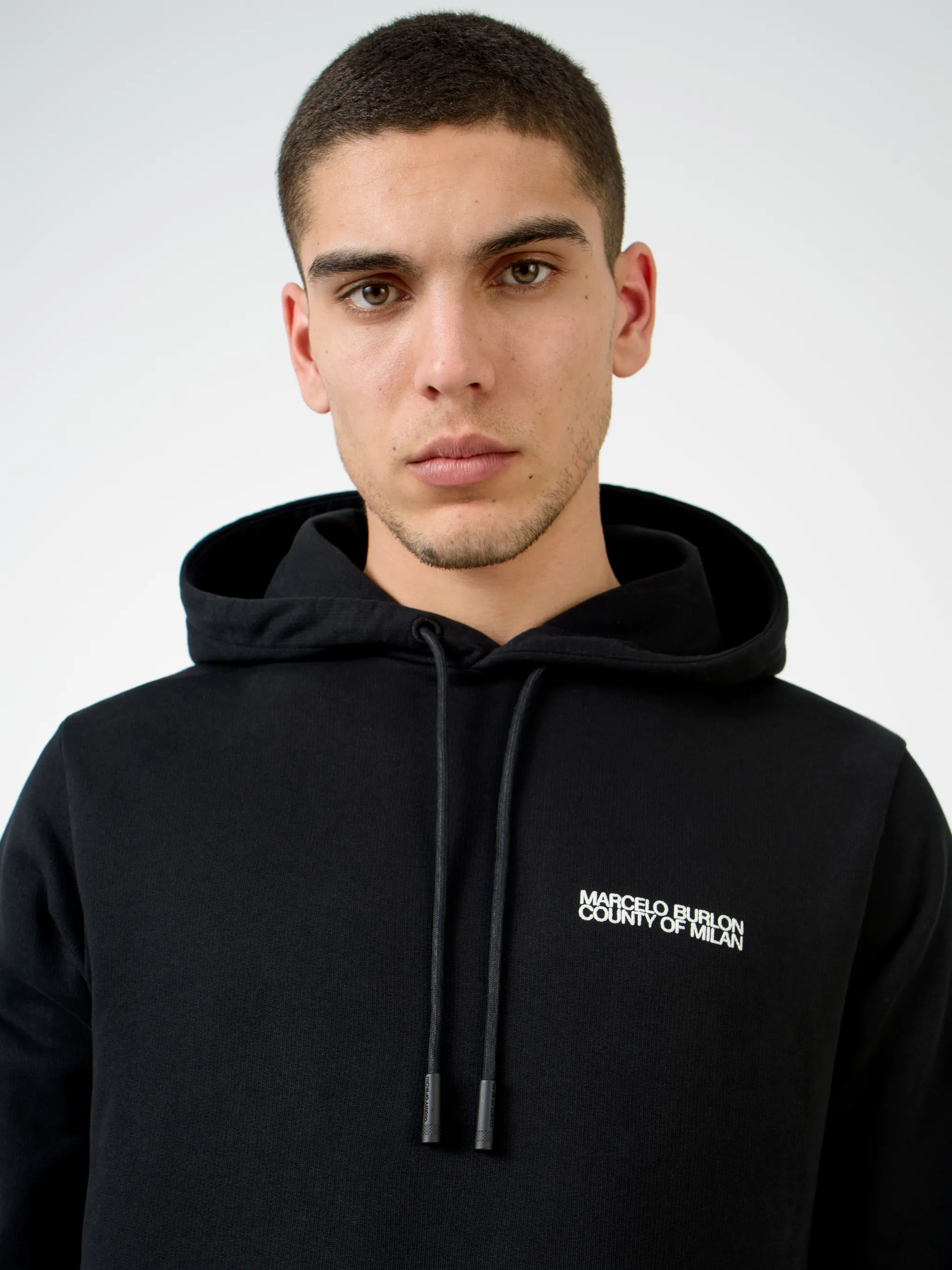 Black cotton Square Outline cotton hoodie from Marcelo Burlon County of Milan featuring logo print at the chest, graphic print to the rear, drawstring hood, long sleeves, front pouch pocket and straight hem.