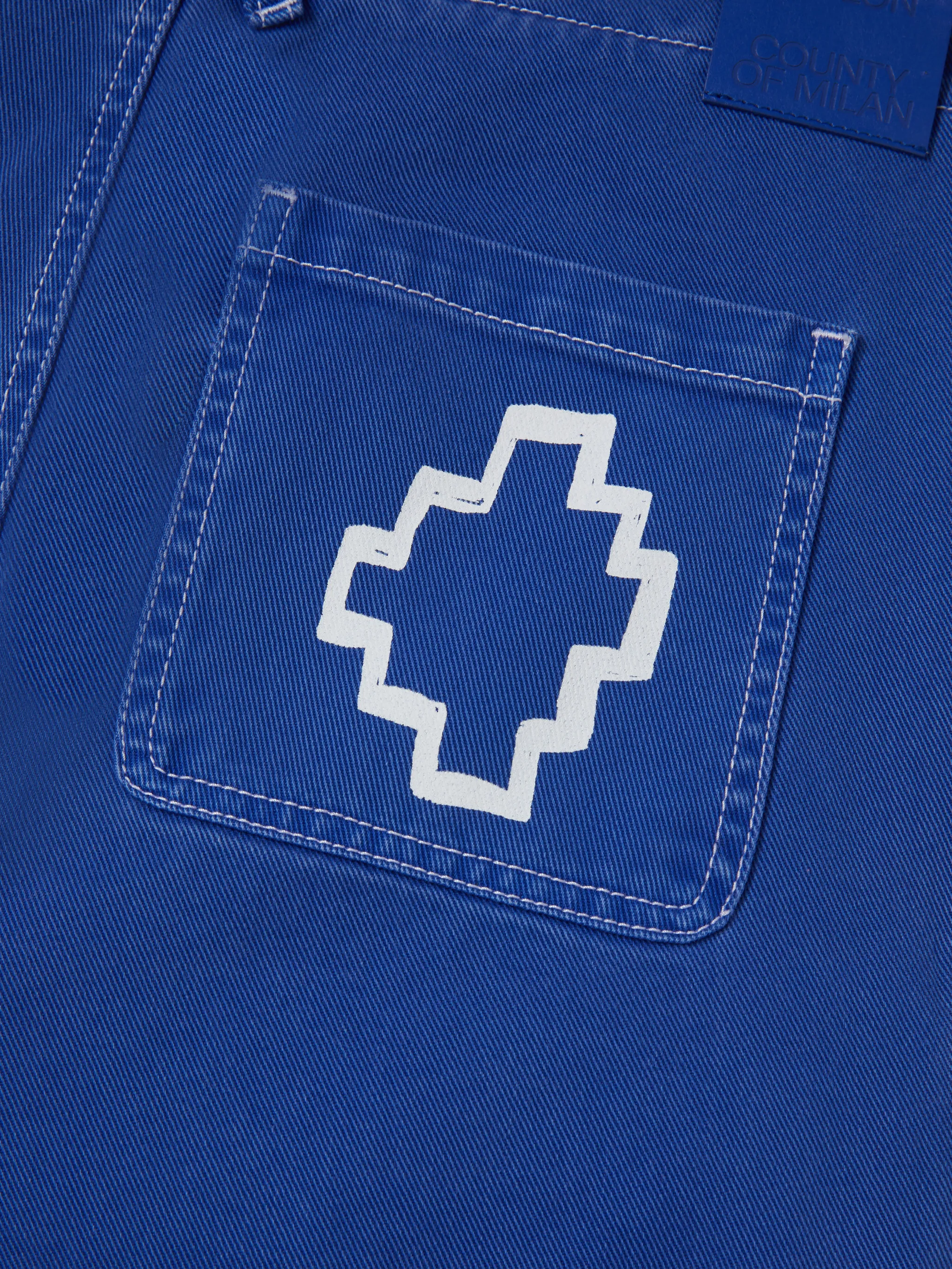 Blue cotton Tempera Cross straight-leg trousers from Marcelo Burlon County of Milan featuring front button and zip fastening, belt loops, straight leg, two side slit pockets, logo patch to the rear, signature Cross motif, contrast stitching and distressed effect.
