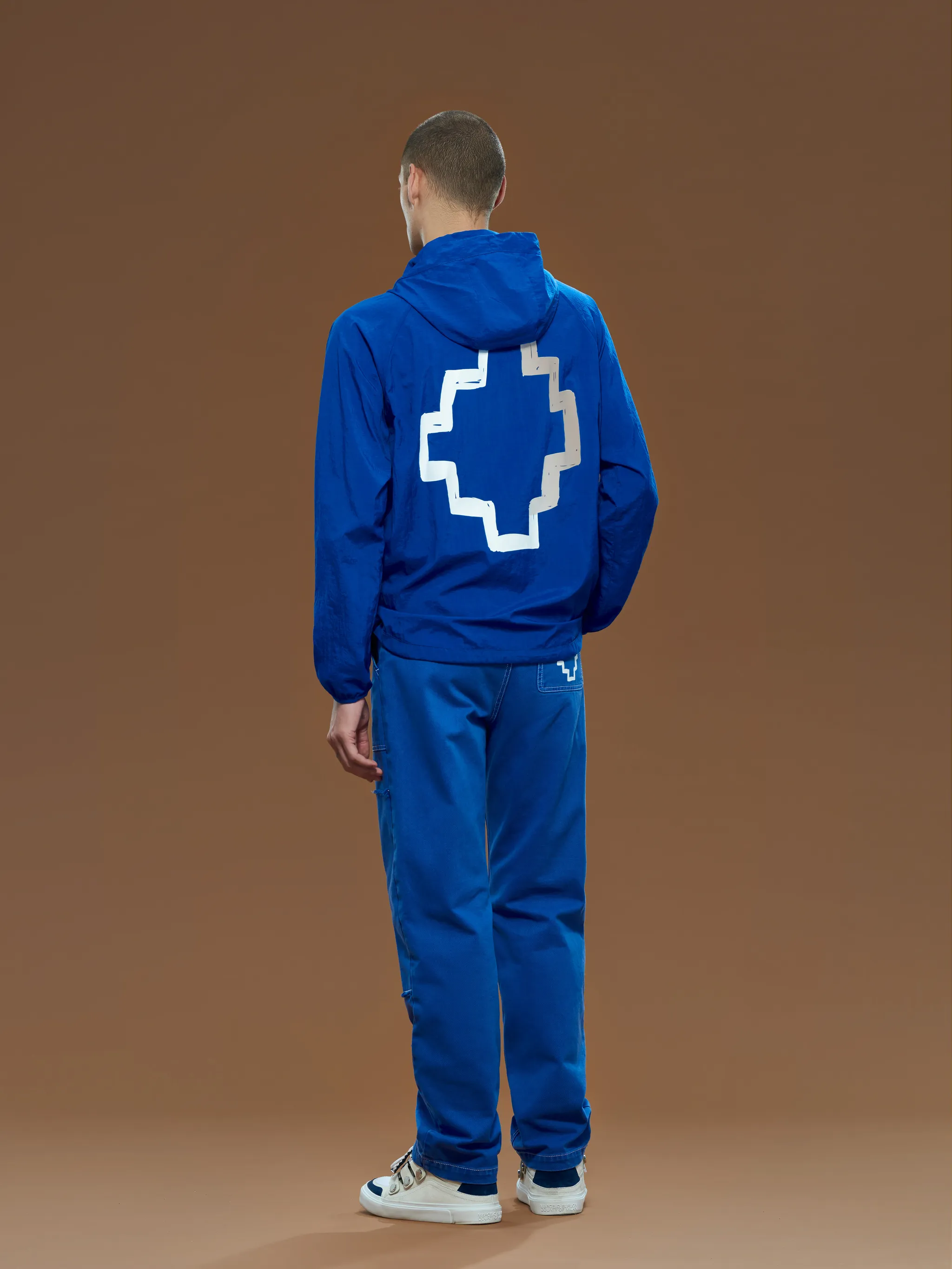 Blue/white Cross-motif windbreaker from Marcelo Burlon County of Milan featuring signature Cross motif, drawstring hood, front zip fastening, long sleeves and two front pouch pockets.