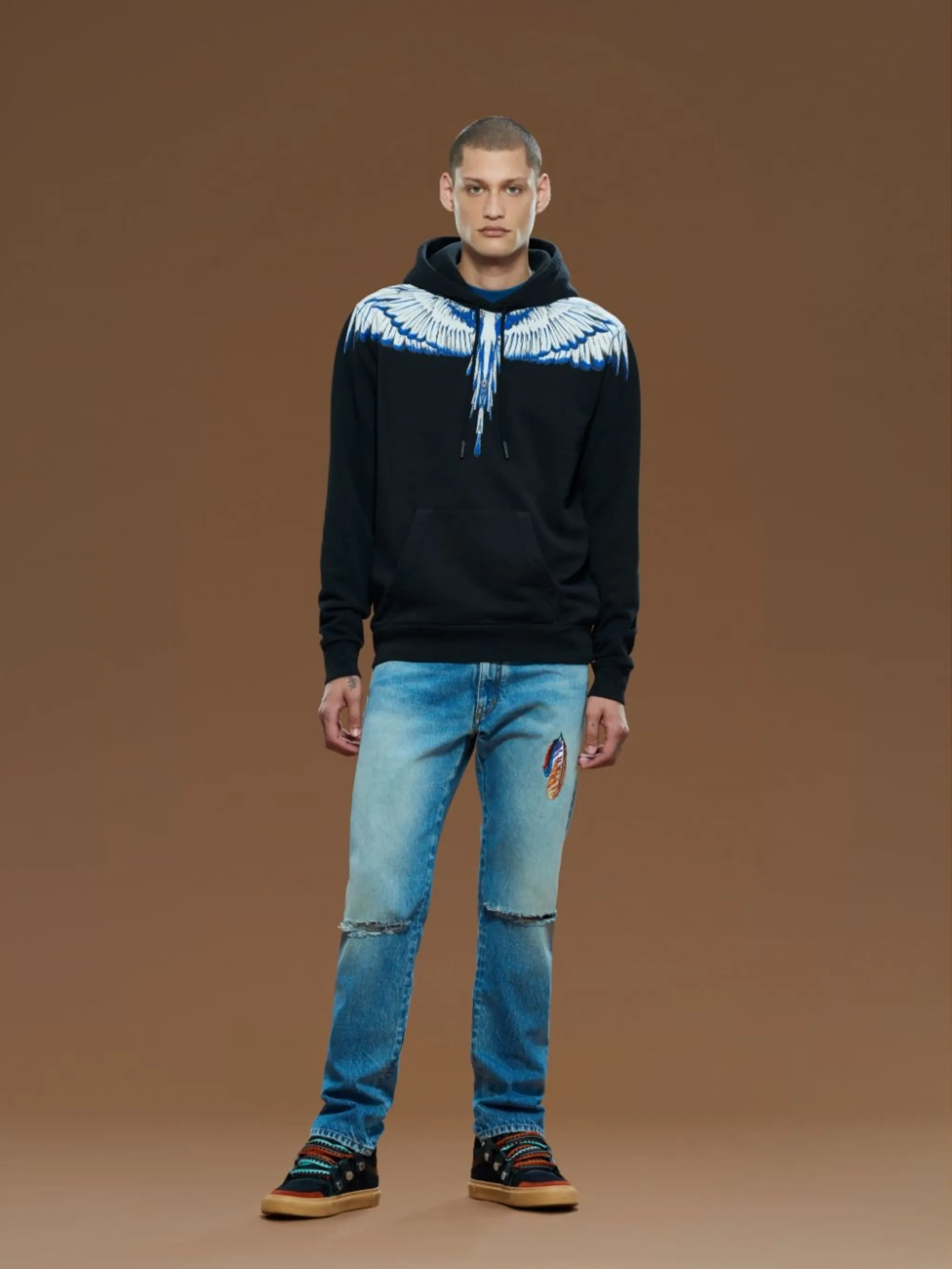 Wings-print drawstring hoodie from Marcelo Burlon County of Milan featuring black, white, blue, cotton, signature Marcelo Burlon Wings print, drawstring hood, long sleeves, front pouch pocket, ribbed hem and ribbed cuffs.