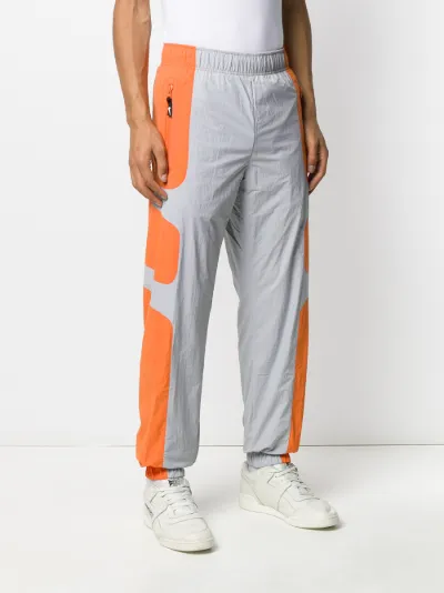 grey and orange track pants