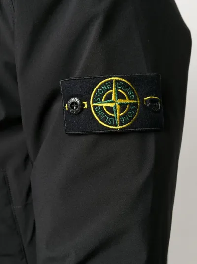 coat with compass logo