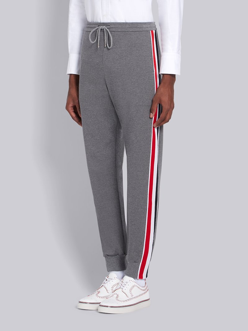 grey pants with red stripe