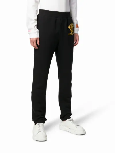 Versace gold-tone logo track pants | Eraldo.com US