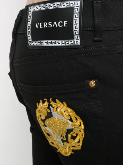 Versace Medusa embroidered slim-fit jeans black | MODES